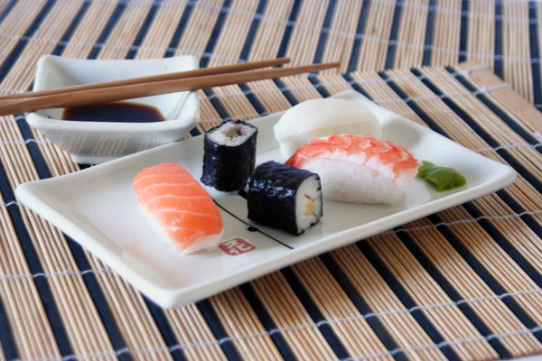 Placa de sushi en mantel de bambú —  Fotos de Stock