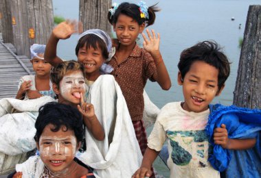 Happy children on U-Bein bridge in Amarapura, Mandalay, Myanmar clipart