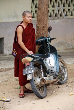 Myanmar monk with motorbike clipart