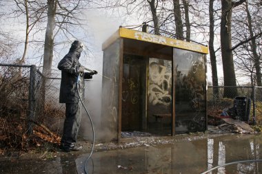 Removing graffiti from bus stop clipart