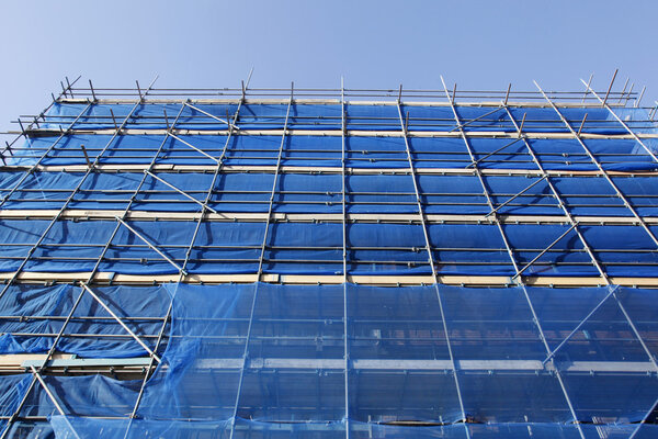 Looking up to blue scaffolding and blue sky