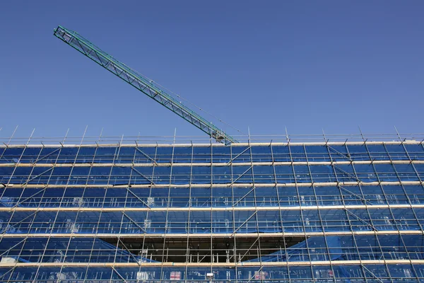Building under construction and scaffolding — Stock Photo, Image
