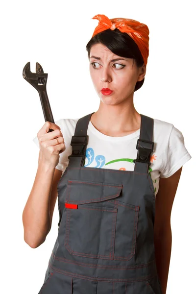Irresolute girl with spanner — Stock Photo, Image