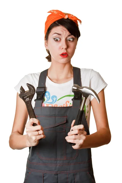 Frightened girl with hammer and spanner — Stock Photo, Image