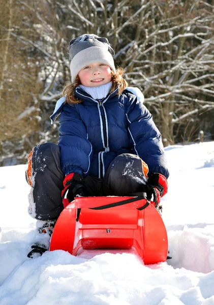 Girl on a sleigh — Stock Photo, Image