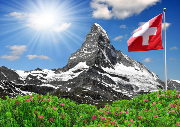 Beautiful mountain Matterhorn with Swiss flag
