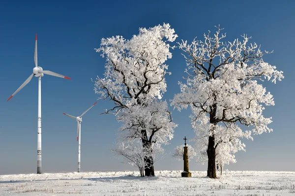 stock image Winter tree with wind turbine