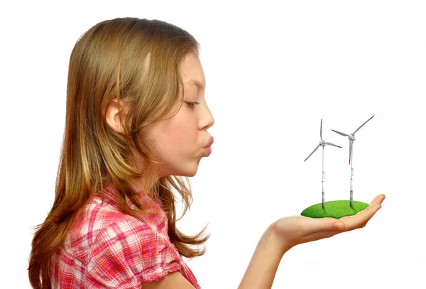 Girl blowing on the wind turbines — Stock Photo, Image