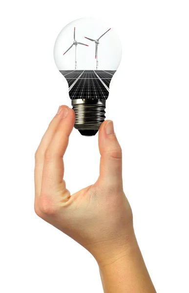 Bombilla con panel solar y turbinas eólicas en la mano —  Fotos de Stock