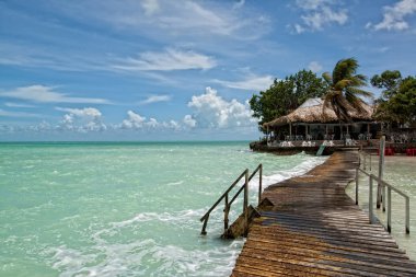 Beatiful bungalo and bridge in caribian sea clipart