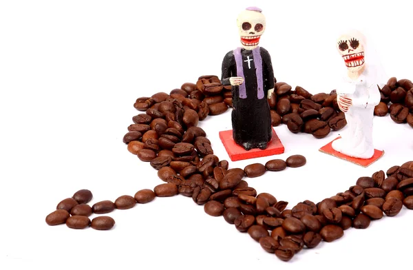 Heart from brown coffee beans with little toys Royalty Free Stock Photos