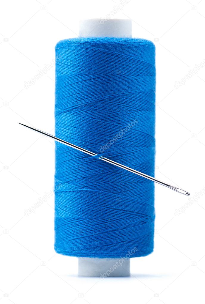Spool of thread and needle isolated on white background