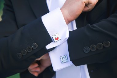 Groom showing cuff links clipart