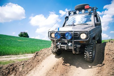 Offroad through muddy field clipart