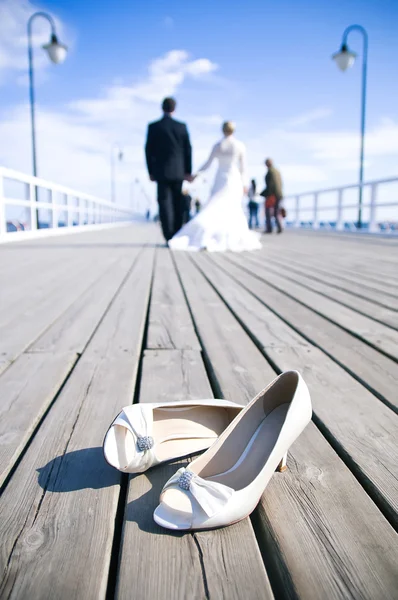 Свадебная пара, идущая по мосту — стоковое фото
