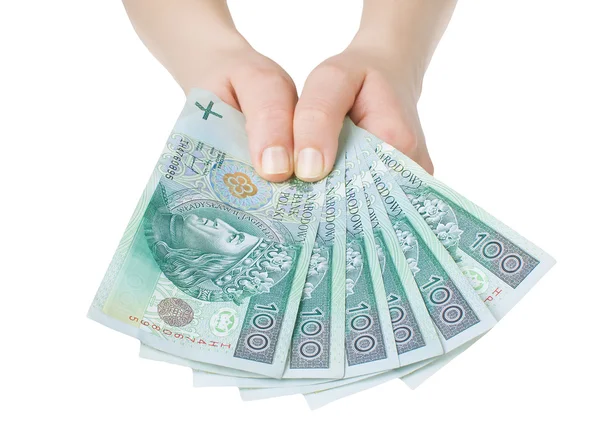 Pools bankbiljetten honderd in vrouwen handen op witte achtergrond — Stockfoto