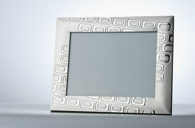 Blank silver picture frame at the table with place for your own clipart