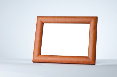 Blank wood picture frame on the table with place for your own text clipart