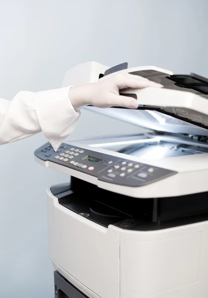 Woman's hand with copier — Stock Photo, Image