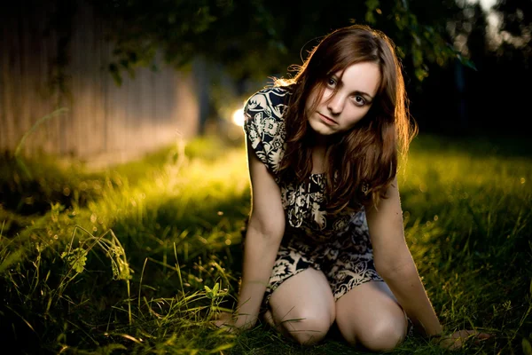 Mujer joven sentada en la hierba — Foto de Stock