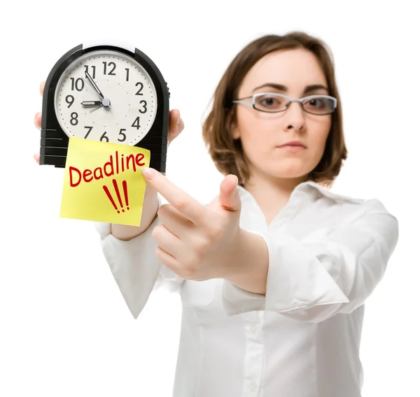 Girl points to clock (focus on clock) — Stock Photo, Image