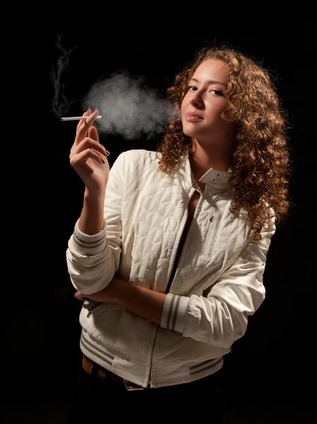 Beautiful woman standing and smoking — Stock Photo, Image