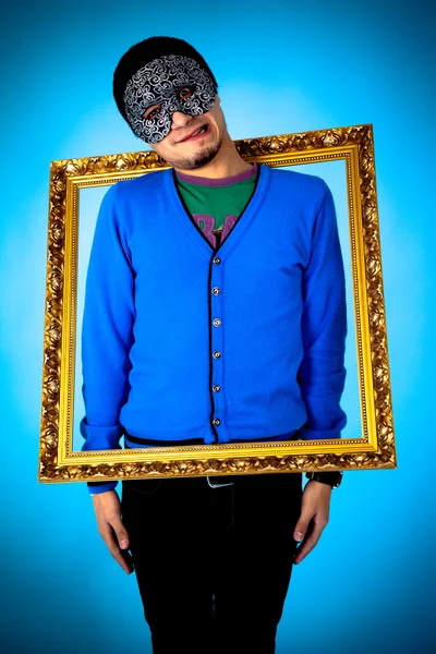 Young funny man with gold frame — Stock Photo, Image