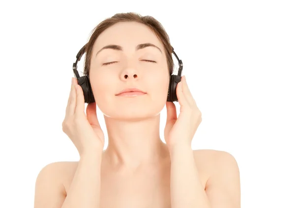 Bella donna nuda per ascoltare musica — Foto Stock
