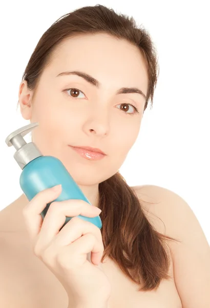 Picture of a beautiful woman with a bottle of a cream — Stock Photo, Image