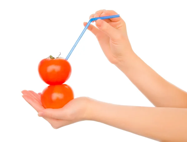 Two tomatos with straw and cocktail umbrella — Stock Photo, Image