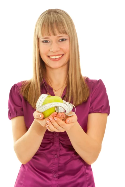 Beautiful woman holding a green apple (focus on apple) — Stock Photo, Image