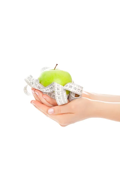 Woman's hands with green apple and measure tape — Stock Photo, Image