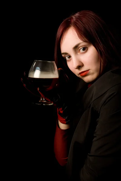 Beautiful girl with a glass of cognac — Stock Photo, Image