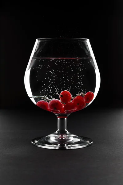 Glass with minerals and red currant — Stock Photo, Image