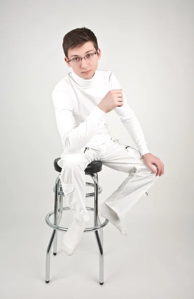 Junger Mann auf einem Barstuhl — Stockfoto