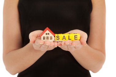 Woman's hands holding house and keys clipart