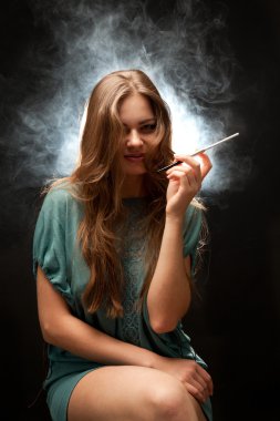 Beautiful woman with full lips sitting and smoking clipart