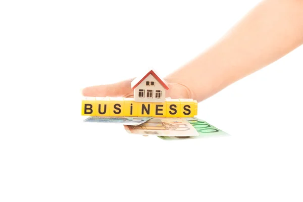 Kvinna hand med ordet affärer och hus med euron — Stockfoto