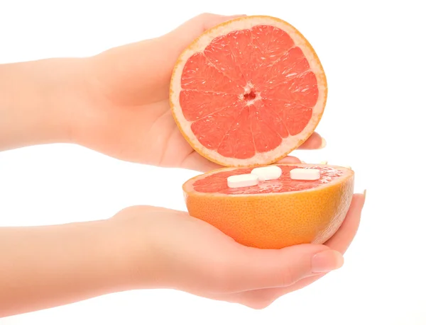 Woman's hands with two pieces of grapefruit — Stock Photo, Image