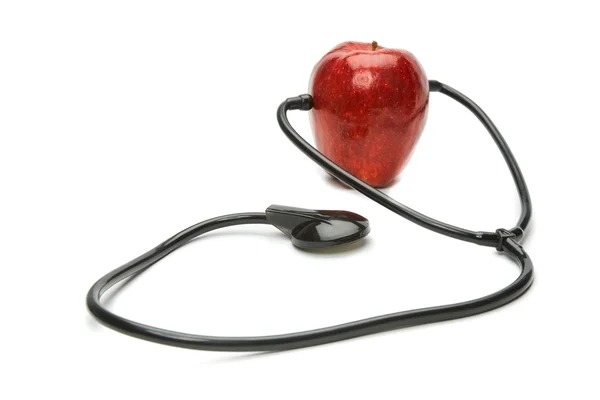 Kırmızı elma ve bir steteskop — Stok fotoğraf