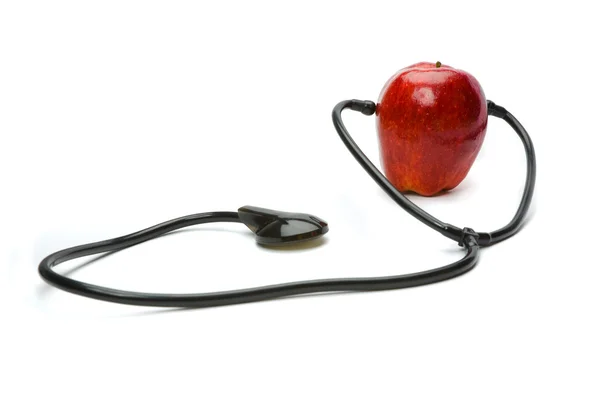A red apple and a stethoscope — Stock Photo, Image