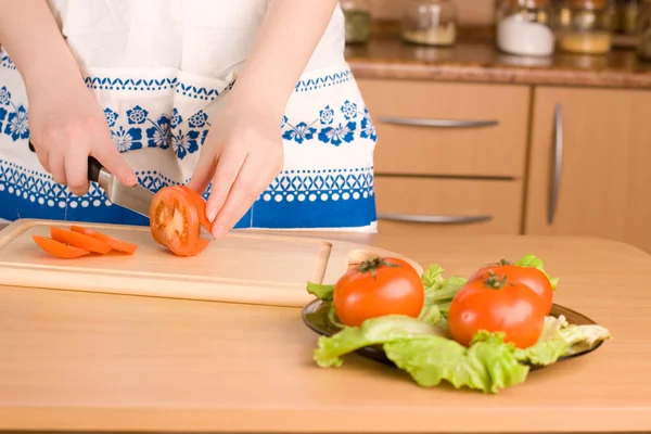 Kvinnans händer skära tomat (med fokus på skärande tomat) — Stockfoto