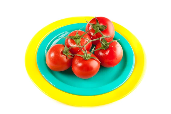 A plate of red tomatoes isolated on white — Stock Photo, Image