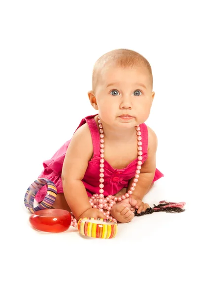 Beautiful baby with a lot of accessories looking to the camera — Stock Photo, Image