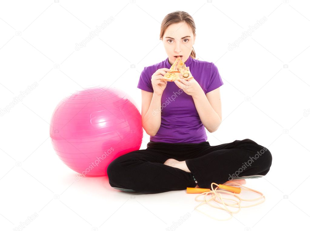 Woman with a slice of pizza and pink gymnastics ball