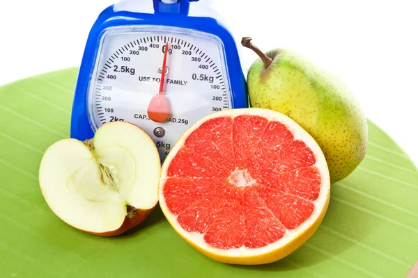 A lot of different fruits and scale — Stock Photo, Image