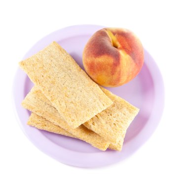 A plate with peach and three crisps clipart