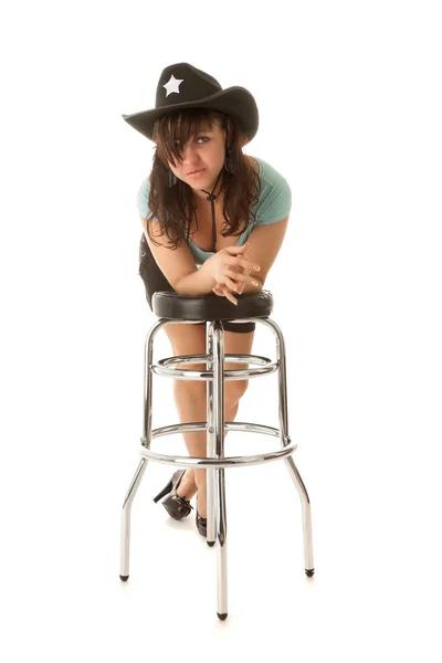 Cowgirl resting on a bar chair — Stock Photo, Image