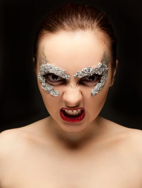 Woman in foil mask looking to the camera — Stock Photo, Image