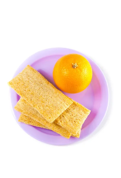 stock image A plate with orange and crisps